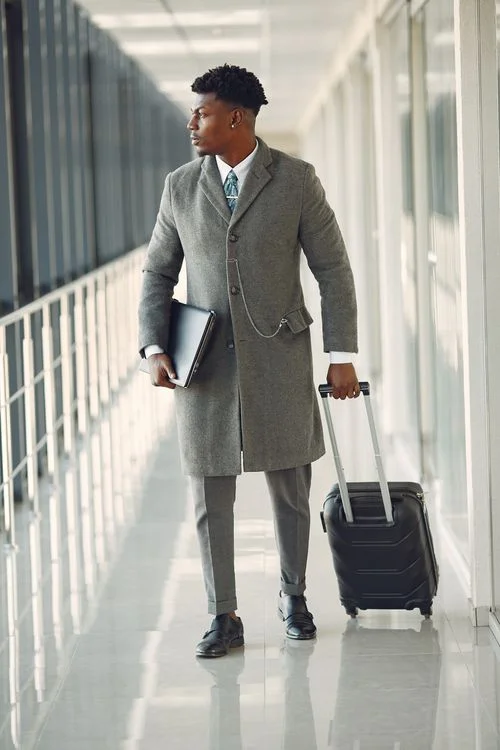 A business traveller with luggage ready for a journey